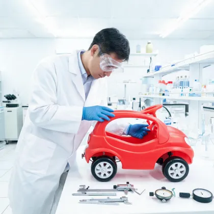 Safety specialist checking ride-on toy stability