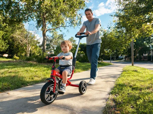 Parent-guided toddler tricycle ride